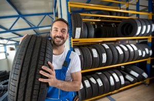 a mechanic grabbing a tire