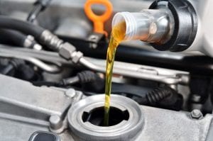 a car engine close-up with an oil change being performed