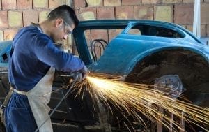 man performing auto body repair in coconut creek