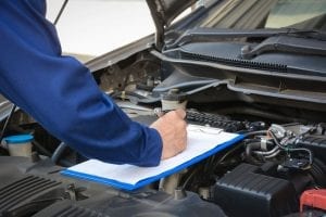 mechanic performing vehicle inspection in coconut creek