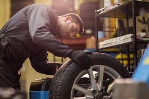 mechanic working on brakes and tires in coconut creek